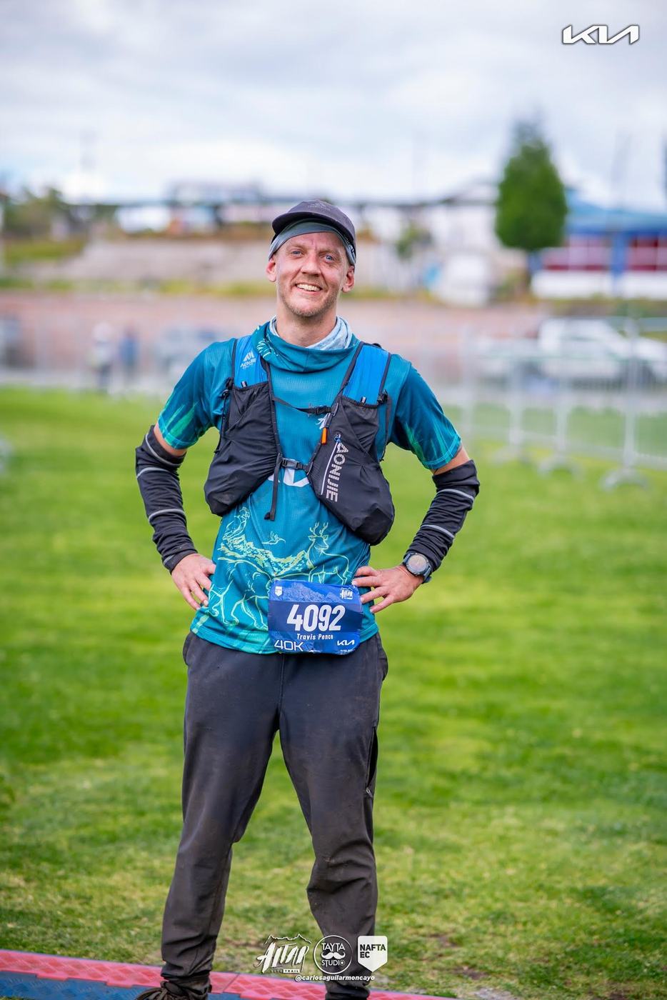 Travis Pence standing with a race medal and bib
