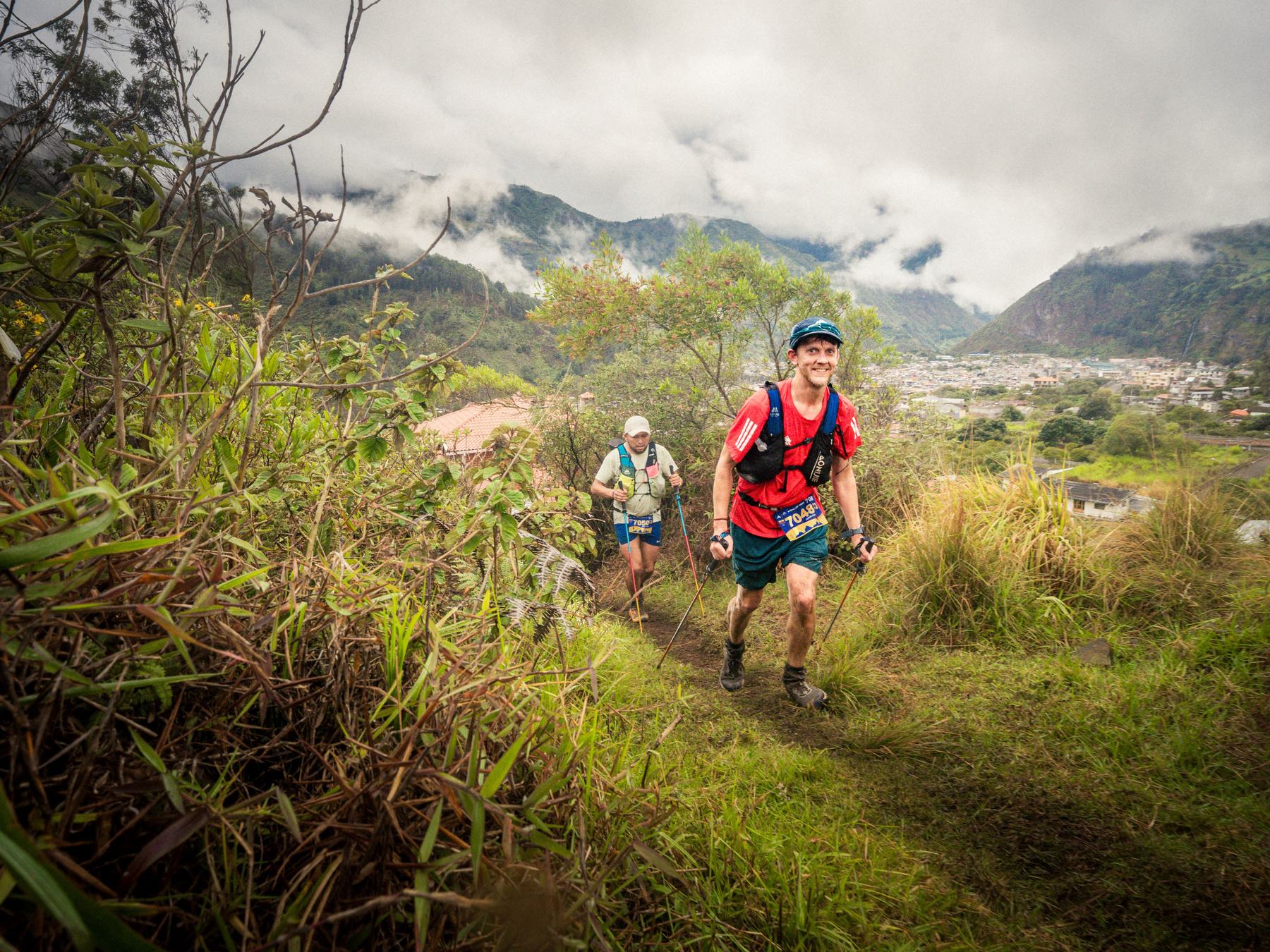 Trail runner climbing through Ecuador mountain terrain